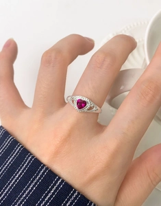Macro detail of S925 silver ring featuring heart-shaped pink corundum and hollow vintage patterns