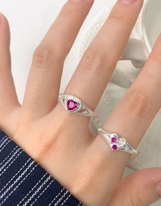 Detailed view of S925 silver heart rings with red corundum and vintage hollowed design