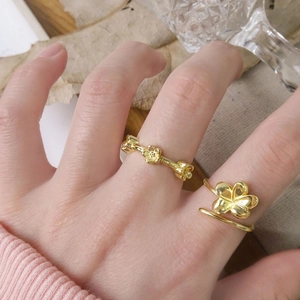 Minimalist gold plated S925 silver flower ring worn on finger with floral details