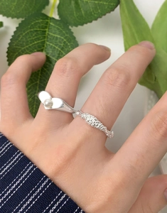 Macro shot of S925 silver double-ring featuring white pearl and heart-shaped motif