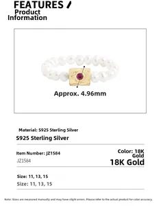 Detail of S925 silver ring with freshwater pearls and a golden centerpiece with red gemstone