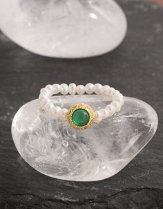Macro view of a S925 silver ring featuring white freshwater pearls and green agate stone