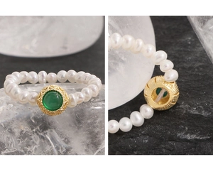 Macro detail of S925 sterling silver stamp on handmade pearl ring with green agate
