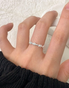 Detail of S925 sterling silver spiral textured ring on finger with industrial aesthetic