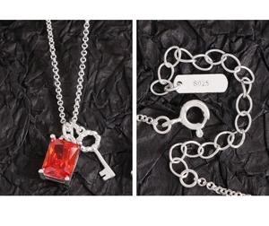 Detailed close-up of S925 sterling silver key necklace with a red square faceted gemstone