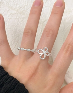 Close-up of a S925 sterling silver set featuring a spiral twist ring and a beaded band