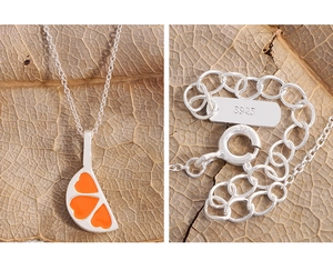Macro shot of S925 sterling silver lobster clasp and heart orange slice pendant