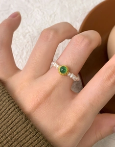 Detailed shot of S925 silver ring featuring freshwater pearls and green agate center