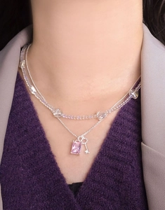 Close-up of double-layer S925 silver necklace with pink gemstone and key pendant