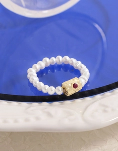 Macro detail of S925 sterling silver hammered beads and red zircon pearl ring