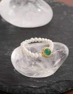 Detailed macro view of S925 silver ring with natural pearls and green agate gemstone