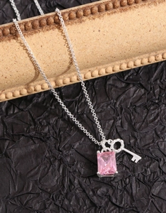 Detailed shot of S925 silver necklace with pink rectangular zircon and key pendant