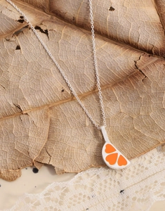 Detailed close-up of S925 silver necklace with orange heart enamel fruit slice pendant