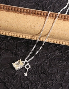 Detailed macro of S925 silver key necklace with champagne zircon and vintage texture