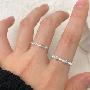 Minimalist S925 sterling silver twist and heart rings on model hand