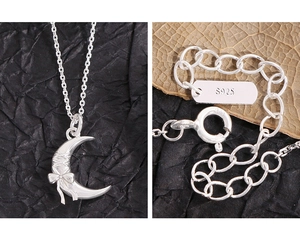 Close-up of S925 sterling silver bow and moon pendant necklace with clasp detail