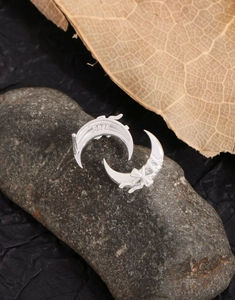 Close-up of S925 sterling silver crescent moon earrings with delicate bow details