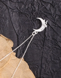 Detail of S925 sterling silver moon and butterfly pendant necklace on a dark background