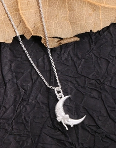Detailed close-up of S925 silver crescent moon necklace with a delicate bowknot design