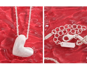 Detailed macro view of S925 sterling silver heart necklace with brushed matte finish