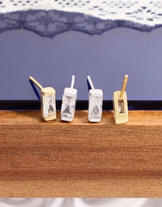 Macro view of rectangular zircon earrings showing S925 silver stamp and polished finish