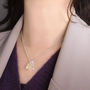 S925 silver key necklace with yellow square zircon pendant worn on model neck