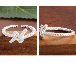 Macro shot of S925 sterling silver stamp on twisted knot open ring inner band
