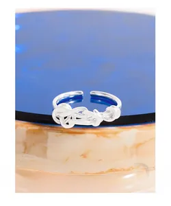 Macro detail of S925 sterling silver stamp on the twisted rope open ring band