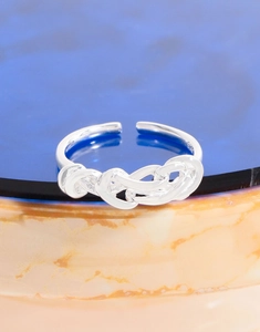 Macro shot of S925 sterling silver stamp on minimalist irregular braided knot open ring