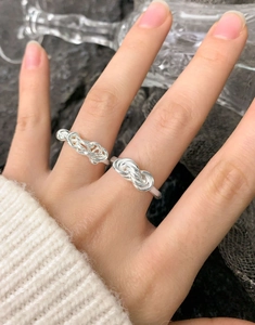 Detail of S925 sterling silver woven knot rings showing intricate intertwined design