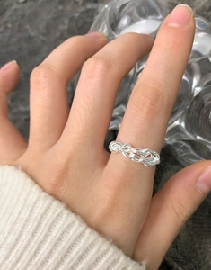 Close-up of S925 sterling silver ring featuring a layered irregular intertwined weave design