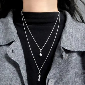 Layered S925 sterling silver necklaces featuring artistic twisted knot pendants for women