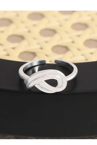 Macro shot of silver S925 hollow knot ring with intricate metallic finish details