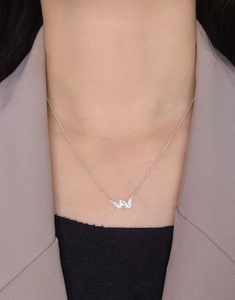 Close-up of S925 silver double butterfly pendant necklace on model collarbone