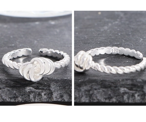 Detail view of twisted S925 sterling silver ring showing intricate knot and hallmark