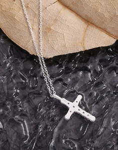 Macro shot of S925 hallmark on polished sterling silver cross pendant necklace