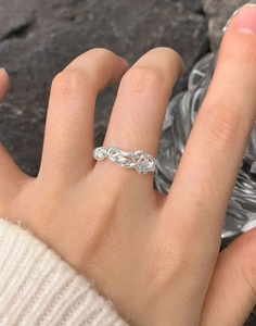 Close-up of S925 sterling silver irregular twisted ring on model finger with macro details