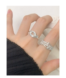 Close-up of S925 sterling silver hollow heart and twisted rope rings for women
