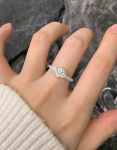 Close-up of S925 sterling silver braided twist knot ring on finger for women