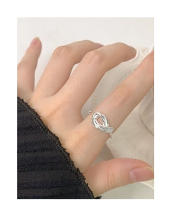 Macro shot of S925 sterling silver hollow twisted knot ring on finger in daily style