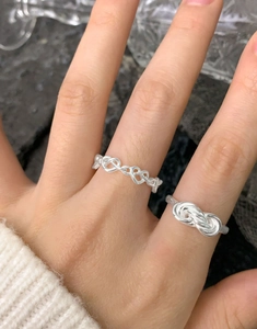 Close-up of S925 sterling silver multi-layer crossover ring and hollow heart chain design