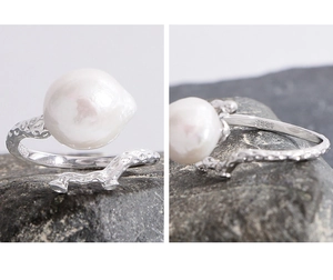 Macro detail of S925 sterling silver branch texture and baroque pearl on the ring