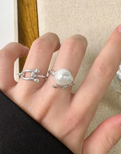 Detail of silver S925 lava texture ring set with large baroque natural pearl on hand