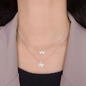 S925 sterling silver double-layered butterfly necklace on a model wearing a blazer