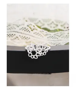 Macro shot of S925 sterling silver hollow flower ring with elegant interlaced line design