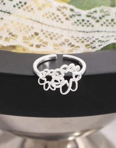 Detailed close-up of S925 sterling silver hollow flower ring with engraved hallmark