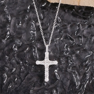 S925 sterling silver cross pendant necklace with sparkling cubic zirconia on black texture