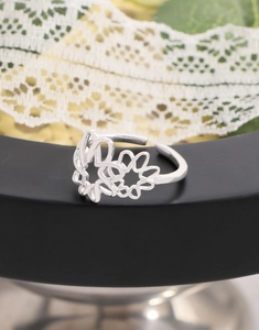 Detailed close-up of hollow floral mesh ring with an adjustable open-back design