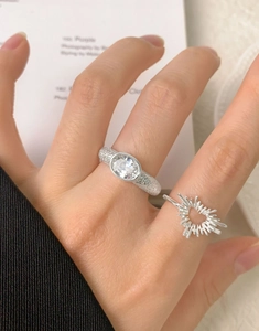 Macro detail of S925 sterling silver irregular heart ring and sunburst pattern on finger