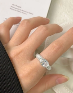 Macro view of S925 silver ring featuring an oval zircon in bezel setting with hammer texture